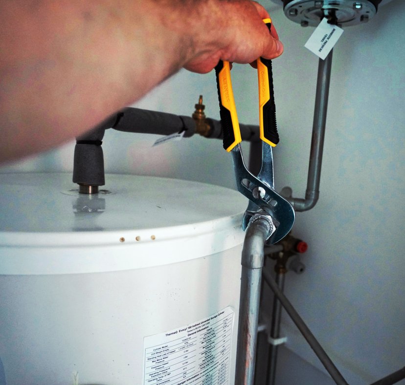 New hot water tank installation in residential basement
